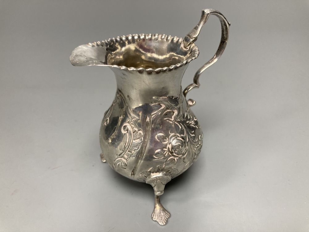 Two 18th century silver cream jugs, London, 1759 & 1768, the former with later embossed decoration,